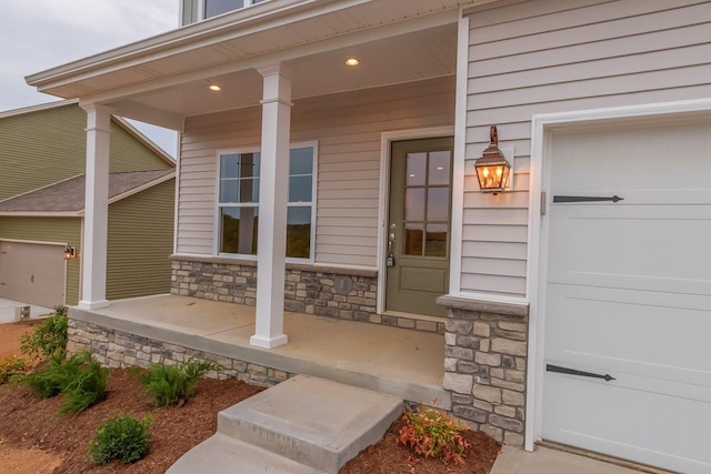 property entrance featuring a porch and stone siding