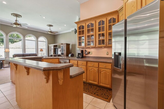 kitchen featuring appliances with stainless steel finishes, sink, a kitchen island, and light tile floors