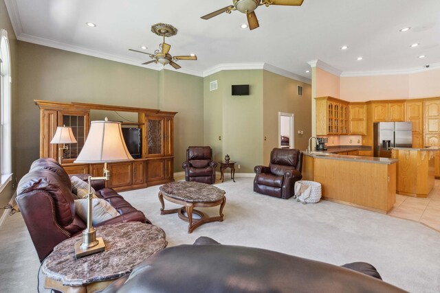 living room with light colored carpet, ceiling fan, and crown molding