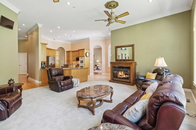 bedroom featuring ornamental molding, ceiling fan, and light hardwood / wood-style flooring