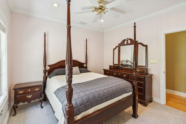 carpeted bedroom with ceiling fan, a closet, and ornamental molding