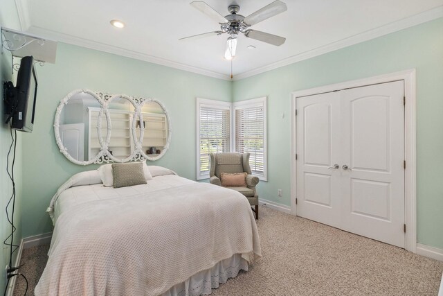 bedroom featuring crown molding, connected bathroom, carpet flooring, and ceiling fan