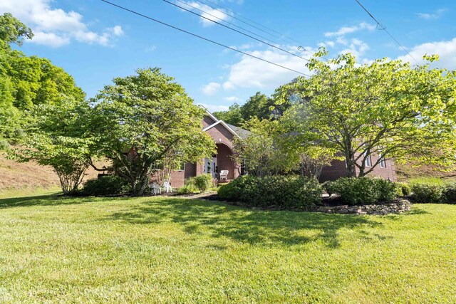 view of front facade featuring a front yard and a patio area