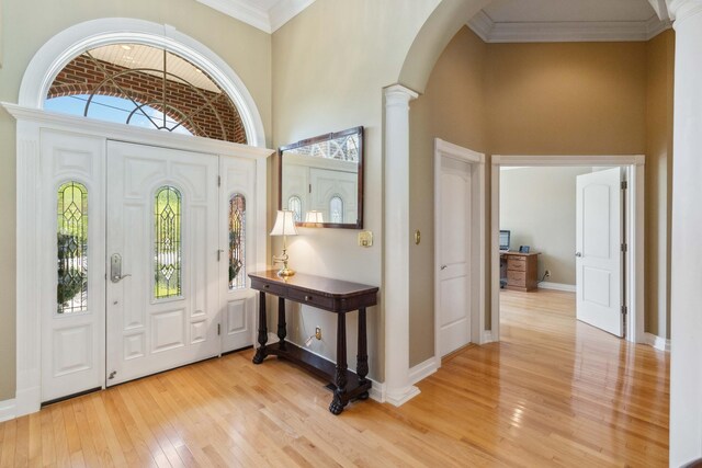 dining space featuring a chandelier, ornate columns, and light wood-type flooring