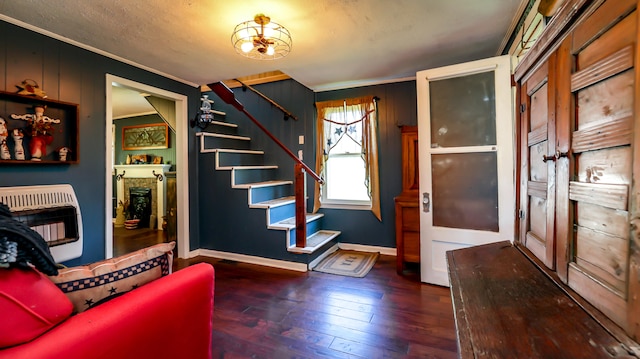 entrance foyer with dark hardwood / wood-style flooring and crown molding