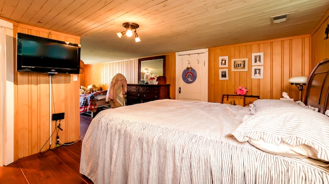 bedroom with dark hardwood / wood-style flooring, a closet, wood walls, and wooden ceiling