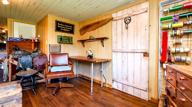 office area with wood walls and dark wood-type flooring