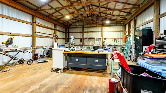 garage with a workshop area and wooden walls