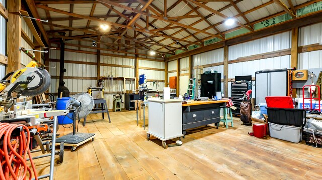 garage featuring a workshop area and wood walls