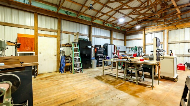 garage featuring wooden walls and a workshop area