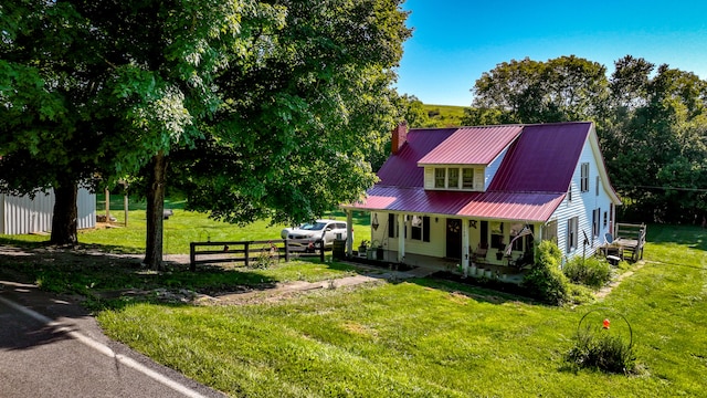 view of front facade with a front yard and covered porch