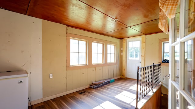 unfurnished sunroom with wooden ceiling