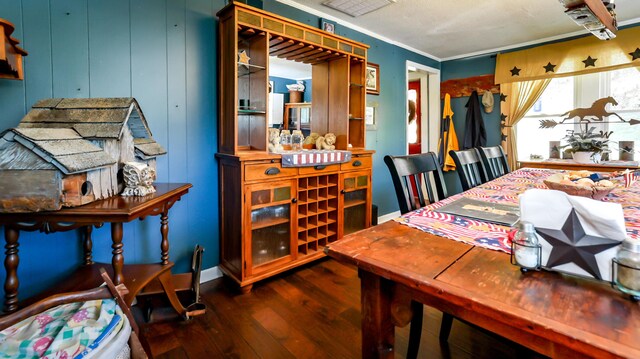 dining area with hardwood / wood-style flooring and ornamental molding