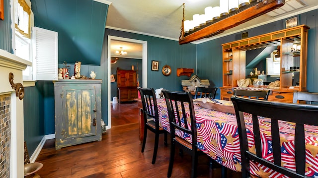 dining room with hardwood / wood-style flooring and crown molding