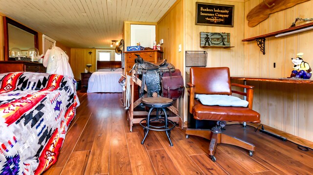 interior space with wooden walls and dark hardwood / wood-style floors