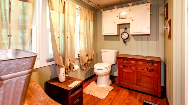 bathroom with toilet and wood-type flooring