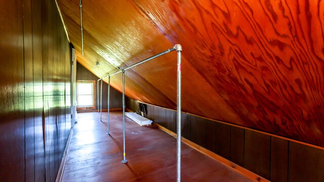 bonus room with wood ceiling, light hardwood / wood-style flooring, wooden walls, and vaulted ceiling