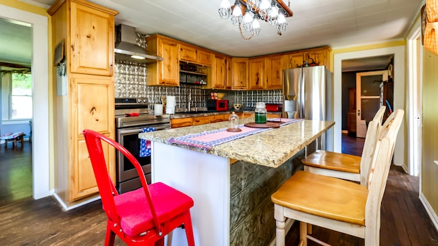 kitchen with wall chimney range hood, range, tasteful backsplash, and a kitchen island