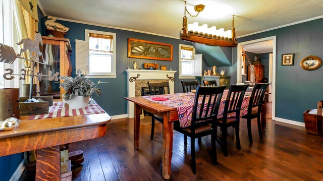 dining space featuring hardwood / wood-style floors and crown molding