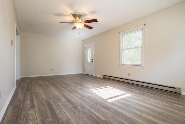 unfurnished room with a textured ceiling, dark hardwood / wood-style floors, baseboard heating, and ceiling fan