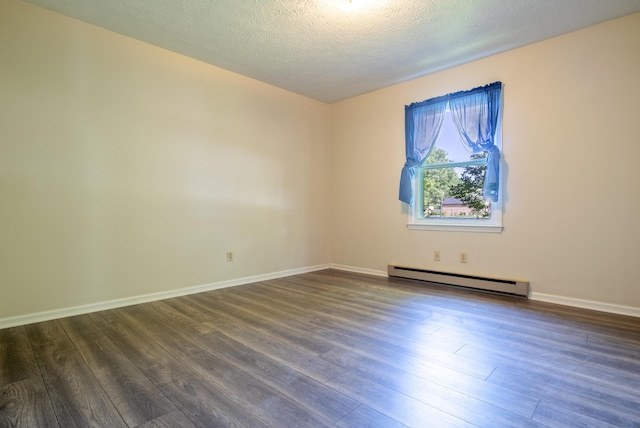 spare room featuring a textured ceiling, dark hardwood / wood-style flooring, and baseboard heating