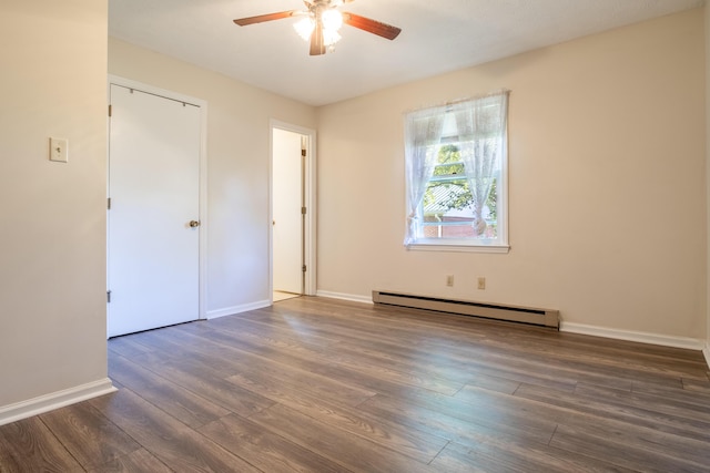 unfurnished bedroom with baseboard heating, a closet, ceiling fan, and dark hardwood / wood-style flooring