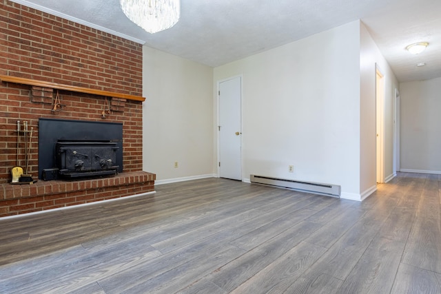 unfurnished living room with a textured ceiling, hardwood / wood-style flooring, an inviting chandelier, and a baseboard heating unit