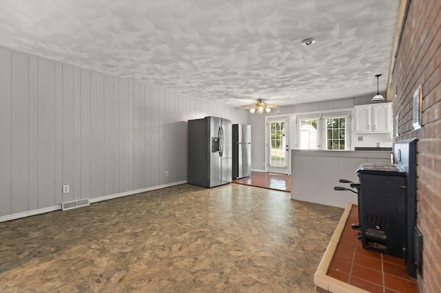 kitchen featuring white cabinetry, stainless steel refrigerator, decorative light fixtures, ceiling fan, and stainless steel fridge