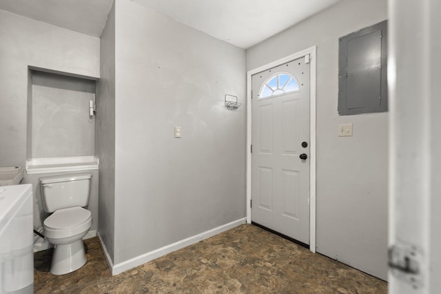 interior space with electric panel and toilet