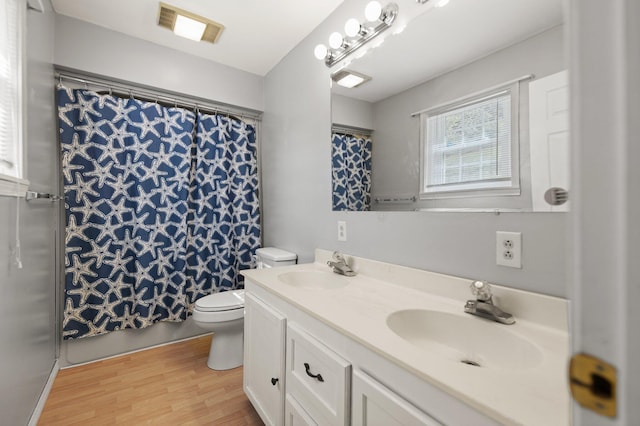 bathroom with vanity, hardwood / wood-style flooring, toilet, and a shower with shower curtain