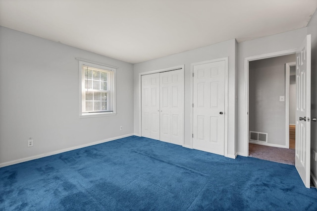 unfurnished bedroom featuring dark carpet