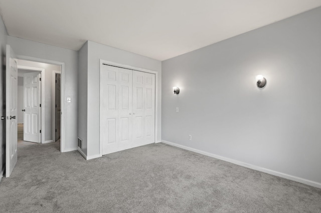 unfurnished bedroom with carpet and a closet