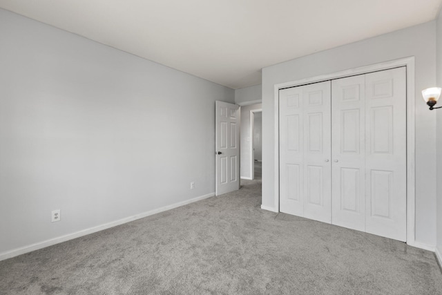 unfurnished bedroom featuring a closet and carpet flooring