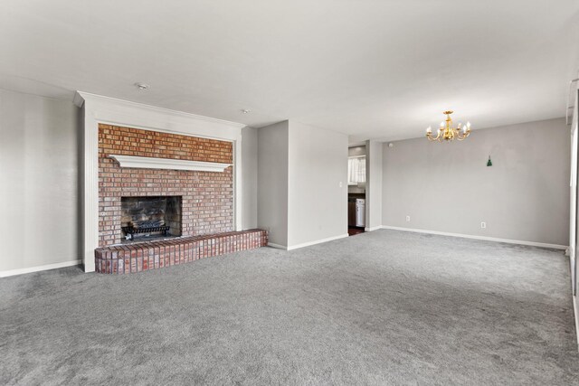 unfurnished living room with dark carpet, a chandelier, and a fireplace