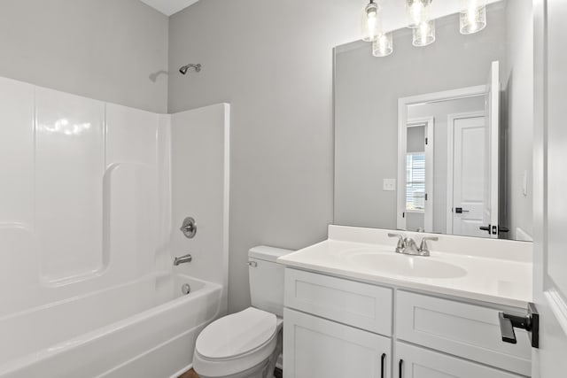 full bathroom featuring vanity, washtub / shower combination, and toilet