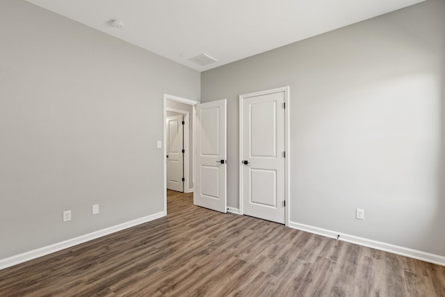 unfurnished bedroom featuring hardwood / wood-style flooring