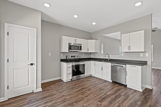 kitchen featuring white cabinetry, stainless steel appliances, and dark hardwood / wood-style floors