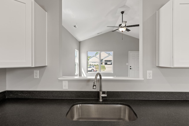 kitchen featuring white cabinetry, ceiling fan, vaulted ceiling, and sink