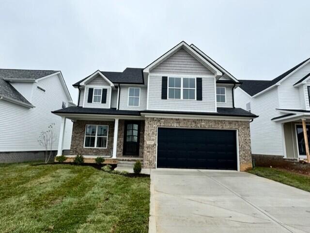 view of front of home featuring a garage and a front yard