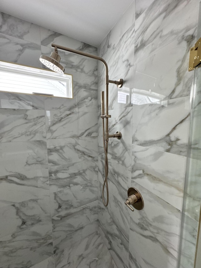 interior details featuring a tile shower