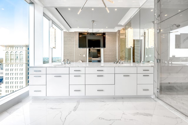 bathroom with tile floors, a shower with shower door, and vanity