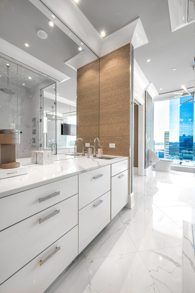 bathroom featuring a healthy amount of sunlight, dual vanity, walk in shower, and tile flooring