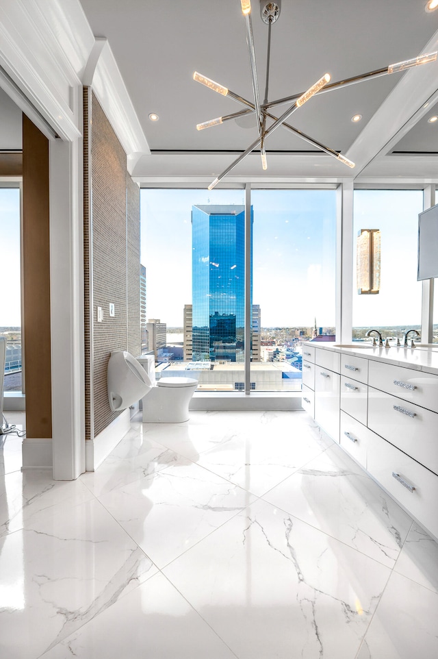 bathroom with tile floors, an inviting chandelier, a wall of windows, and vanity