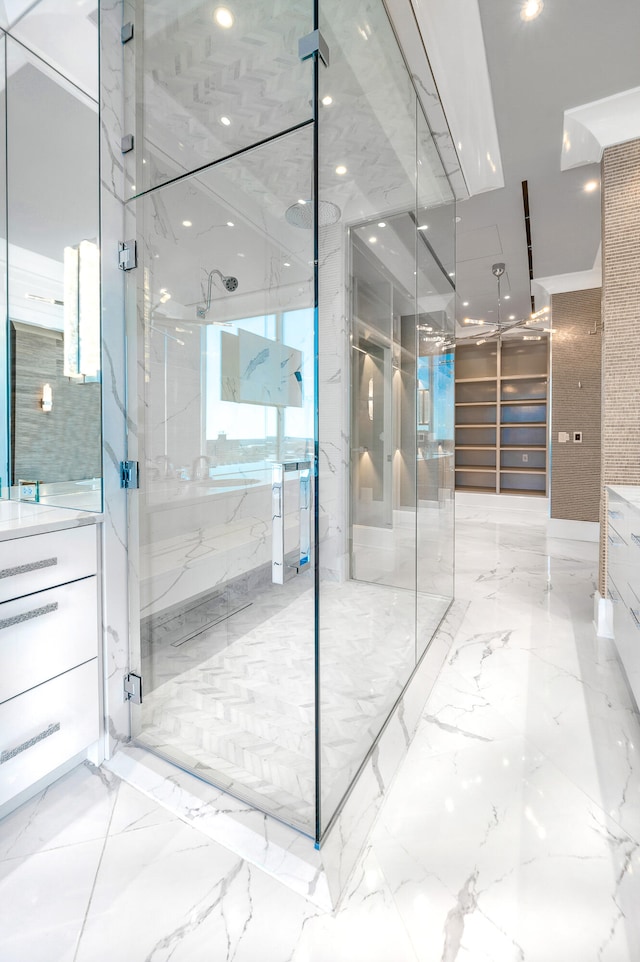 bathroom with tile floors, a shower with shower door, and vanity