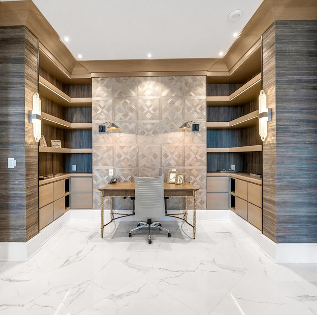 unfurnished office featuring tile floors and built in desk