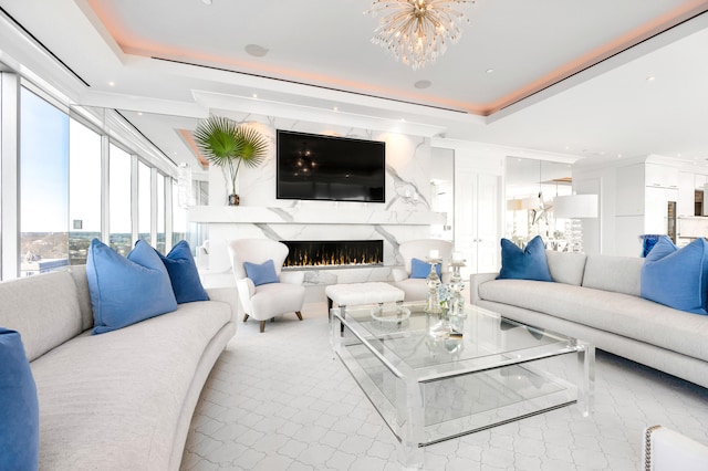 living room featuring a notable chandelier and a raised ceiling