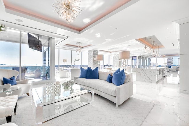 tiled living room with floor to ceiling windows, an inviting chandelier, plenty of natural light, and a tray ceiling