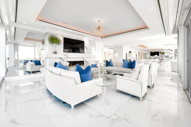 living room featuring light tile flooring, a high end fireplace, and a raised ceiling