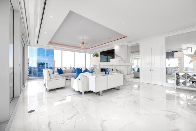 tiled living room featuring a healthy amount of sunlight and a raised ceiling