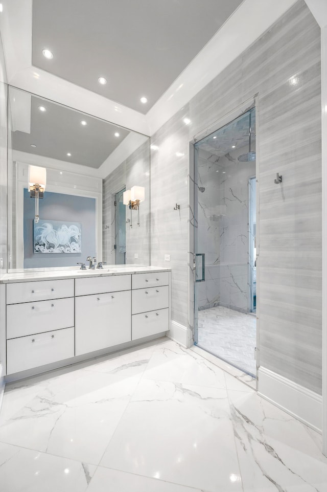 bathroom with tile floors, a shower with door, and vanity